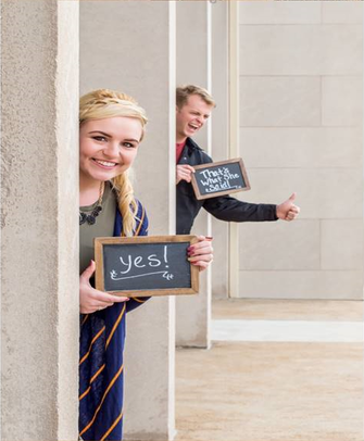 Couple posing with signs