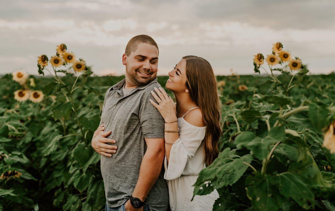 Couple posing in a sunflower field