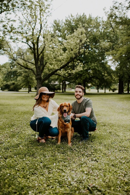 Couple posing in park with dog