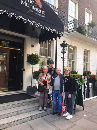 Stephanie, her husband Will, and their two grandsons outside of their hotel in Paris.