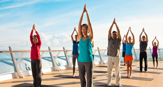 Crowd doing yoga on cruise ship deck